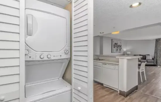 In-unit washer/dryer with open-concept kitchen and living area