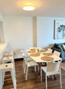 Bright modern dining area with seating for 6 plus breakfast bar stools
