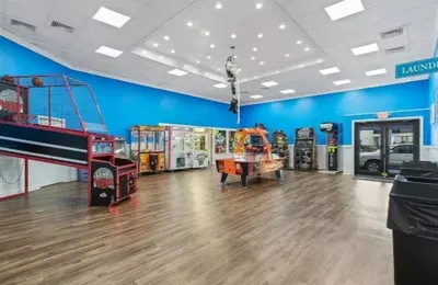 Spacious arcade room with air hockey, basketball games, and family fun