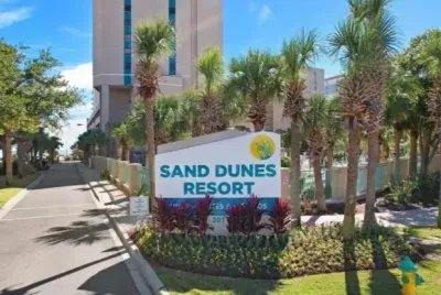Tropical resort entrance with palm-lined drive and lush landscaping