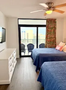 Bright double bedroom with balcony seating and city-view natural light