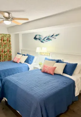 Bright double-bedroom with two cozy beds and cheerful coastal charm