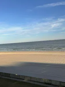 Unobstructed oceanfront vista over a wide, tranquil sandy beach.