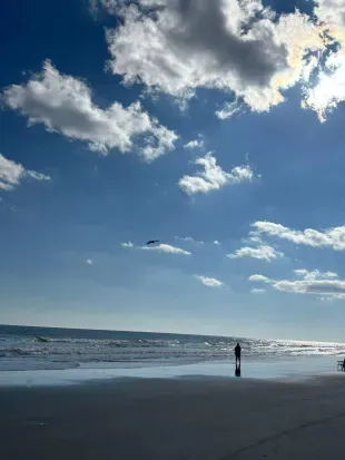 Uncrowded sandy shoreline with sweeping ocean views—steps from your stay.