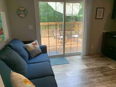 small living room area with a 32" TV that includes Disney+