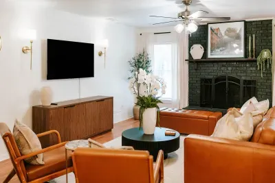 Open living area centered around cozy seating and a statement fireplace.