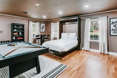 Unique game room retreat blending entertainment, comfort, and flexible sleeping space.