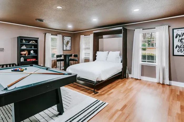 Unique game room retreat blending entertainment, comfort, and flexible sleeping space.