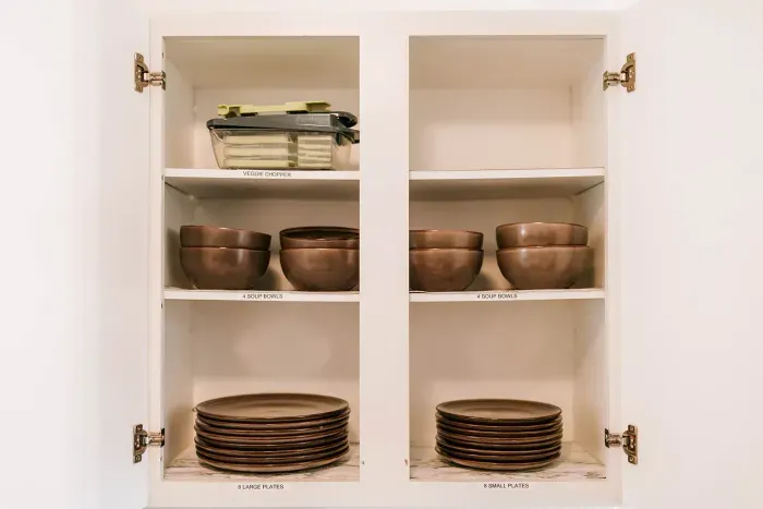 Well-organized kitchen cabinets stocked for everyday cooking and dining.