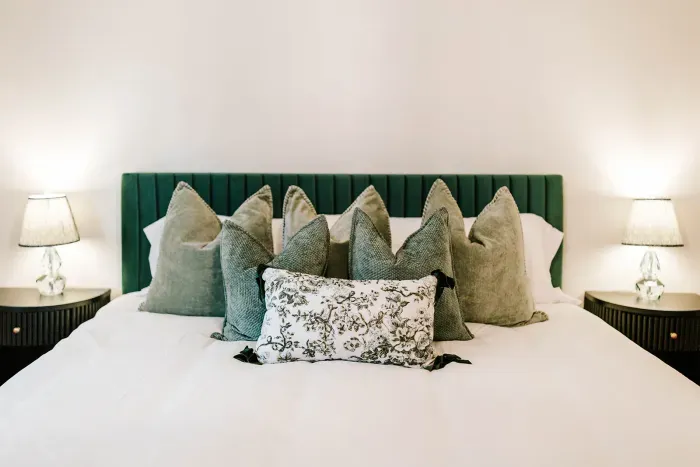 Layered textures and calming tones create a cozy, thoughtfully styled retreat.