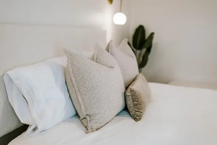 Soft, inviting pillows and warm textures designed for elevated comfort.