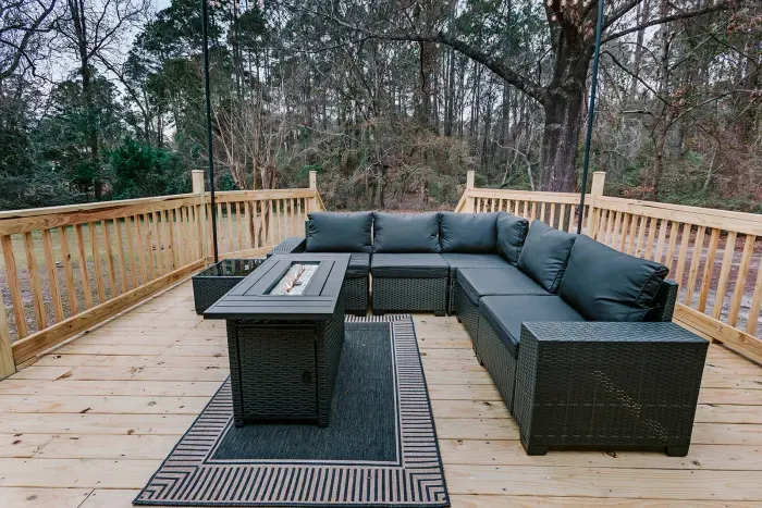 Spacious deck with comfortable outdoor seating for relaxing and entertaining.