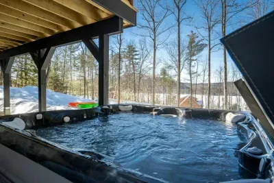 Soothe your tired muscles in our opulent hot tub after an exhilarating day of skiing or snowmobiling, all while enjoying breathtaking vistas of the lake and mountains.