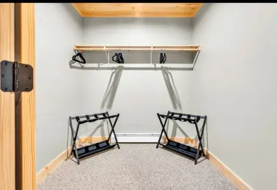 Experience exceptional organization in this spacious master closet. With luggage racks, ample hangers, storage shelf, and a full-length mirror, it meets all your garment needs while blending style and practicality for a seamless dressing experience.