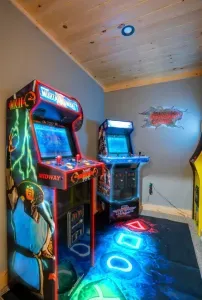 Enter an electrifying arcade room featuring iconic games like Pac-Man, Mortal Kombat, and NFL Blitz. Immerse yourself in thrilling battles and classic gameplay that captivate both nostalgic players and new fans. No quarters needed!