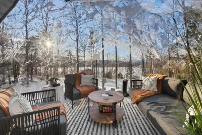 From inside the luxury dome,  breathtaking view of a tranquil lake. Soft, warm lighting adds a cozy touch, perfectly blending the serene outdoor scenery with the comfort of the dome's elegant interior.