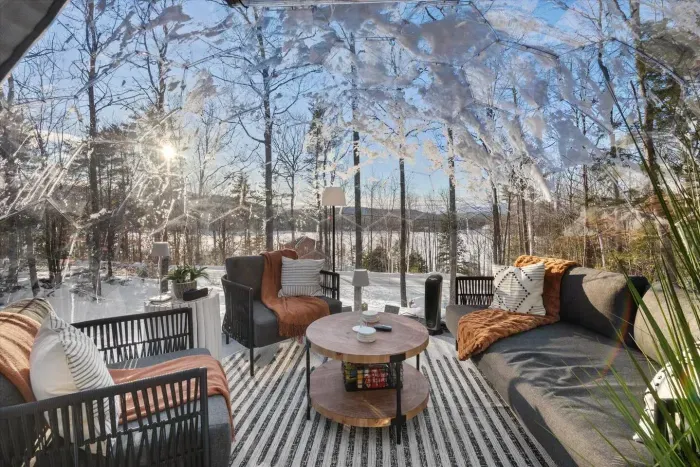 From inside the luxury dome,  breathtaking view of a tranquil lake. Soft, warm lighting adds a cozy touch, perfectly blending the serene outdoor scenery with the comfort of the dome's elegant interior.