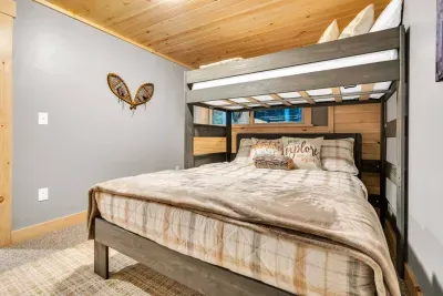 Bedroom 4 has a Smart TV, offering a vast selection of entertainment. Stream the latest movies and shows, explore countless digital channels, and enjoy personalized viewing that caters to every mood, ensuring your stay is both relaxing and delightful