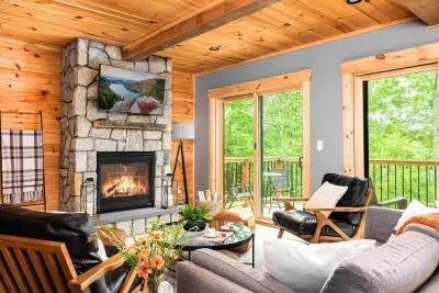 Snuggle up by the crackling fireplace in our welcoming living room, a haven of warmth and comfort. With three sets of sliding glass doors, the space is bathed in natural light, creating a bright and airy ambiance that invites relaxation.