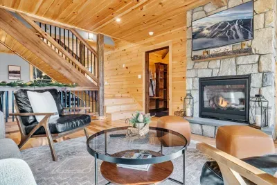 The cozy living room centers around a remote-controlled gas fireplace, topped with a smart TV for streaming your favorite shows and movies. The modern design offers a seamless blend of warmth and technology, creating an inviting space for relaxation.