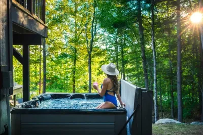 Nestled amidst tranquil beauty, our hot tub offers breathtaking seasonal lake and mountain views. This peaceful oasis invites you to unwind and soak in nature's splendor, providing the perfect escape to relax and rejuvenate amid stunning landscapes.