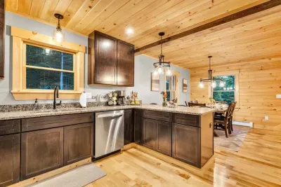 Discover a dedicated tea and coffee bar featuring a drip coffee maker, French Press, local coffee, teas, honey sticks, branded mugs, and all the essential accessories for crafting the perfect brew.  This inviting space caters to every preference.