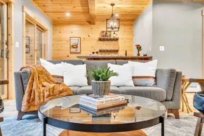 Relax on our exceptionally cozy sofa, enveloped by plush pillows and throw blankets, and take in the picturesque outdoor views, crafting a warm and inviting setting ideal for unwinding.