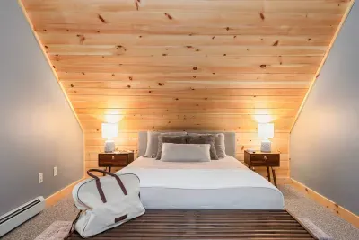 A queen bed awaits amidst soft, soothing colors that evoke tranquility. Experience ultimate comfort in a serene setting, designed to calm the senses and provide a peaceful retreat for restful nights and rejuvenating mornings.