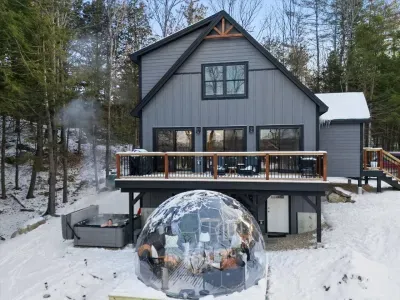 Escape to a backyard oasis featuring an outdoor dome, cozy fire pit, relaxing hot tub, and elevated deck. Enjoy seasonal lake and mountain views in a space perfect for unwinding or gathering. Nature, comfort, and stunning scenery await you!