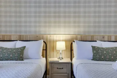 Neutral tones meet nature-inspired design. Our Birch Room features custom plaid wallpaper and wood accents at this pet-friendly Poconos vacation rental near Lake Harmony. Hotel-quality linens included for your group getaway.