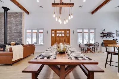 Gather everyone around our custom wood dining table that seats 8-10 guests at the Pocono Barndominium. Perfect for celebratory dinners, game nights, and making memories near Jim Thorpe and Lake Harmony.