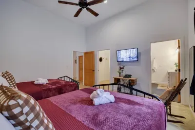 Everything you need in one spacious room. The Maple suite features Smart TV, ensuite bathroom, walk-in closet, and dedicated workspace at the Pocono Barndominium, a luxury group rental minutes from Jim Thorpe.