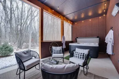Relax in the covered outdoor oasis! Soak in the 7-person hot tub, lounge on cozy patio seating, watch the 65-inch TV, and stay warm with the outdoor heater. Surrounded by woods, this space offers the perfect blend of comfort and nature!