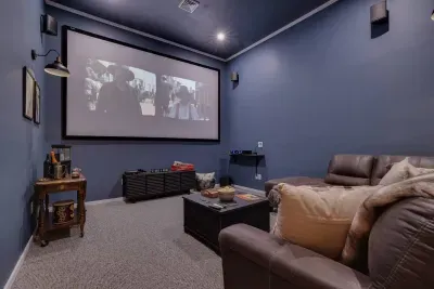 Make a bowl of popcorn and gather around the home theater to watch a movie. This room also converts into a bedroom with a pull out couch to get extra cozy!