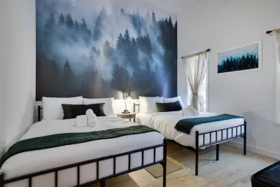 Sleep under the pines in our Pine Room at the Pocono Barndominium. Two full beds sleep 4 guests with stunning forest-inspired art. This luxury Poconos group rental near Jim Thorpe sleeps 14 total for celebrations.