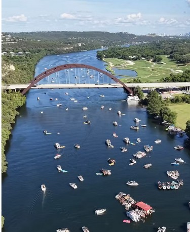 Lake Austin aerial view with boats and Pennybacker Bridge
