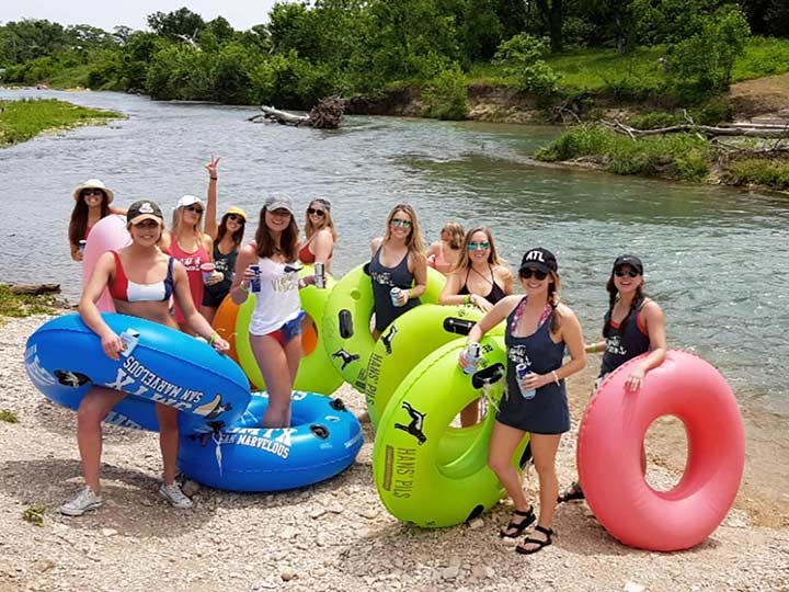 River tubing group with colorful tubes Austin