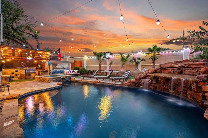 Austin bachelorette party pool house at sunset - ATX Oasis private heated pool with string lights