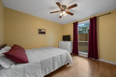 Second bedroom of the bungalow with queen sized bed and tv.
