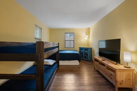 Third bedroom of the bungalow with twin over twin bunk bed and queen sized bed with trundle underneath.