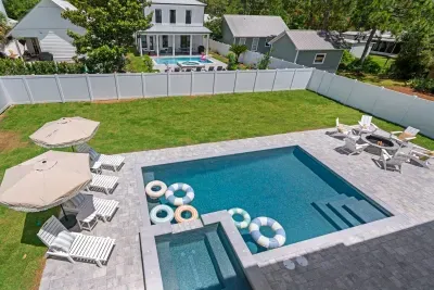 Backyard oasis with pool, hot tub, fire pit, loungers & putting green, tiki bar and outdoor seating for all 22 of your closest friends!