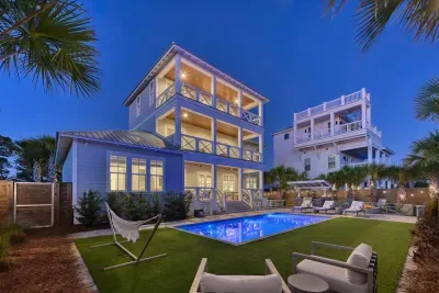 Resort backyard featuring heated pool, loungers, fire pit, outdoor kitchen and dining areas!