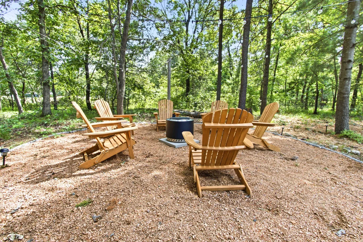 Wooden Adirondack chairs around the fire pit at Chalet on the Fairway Nekoosa, WI