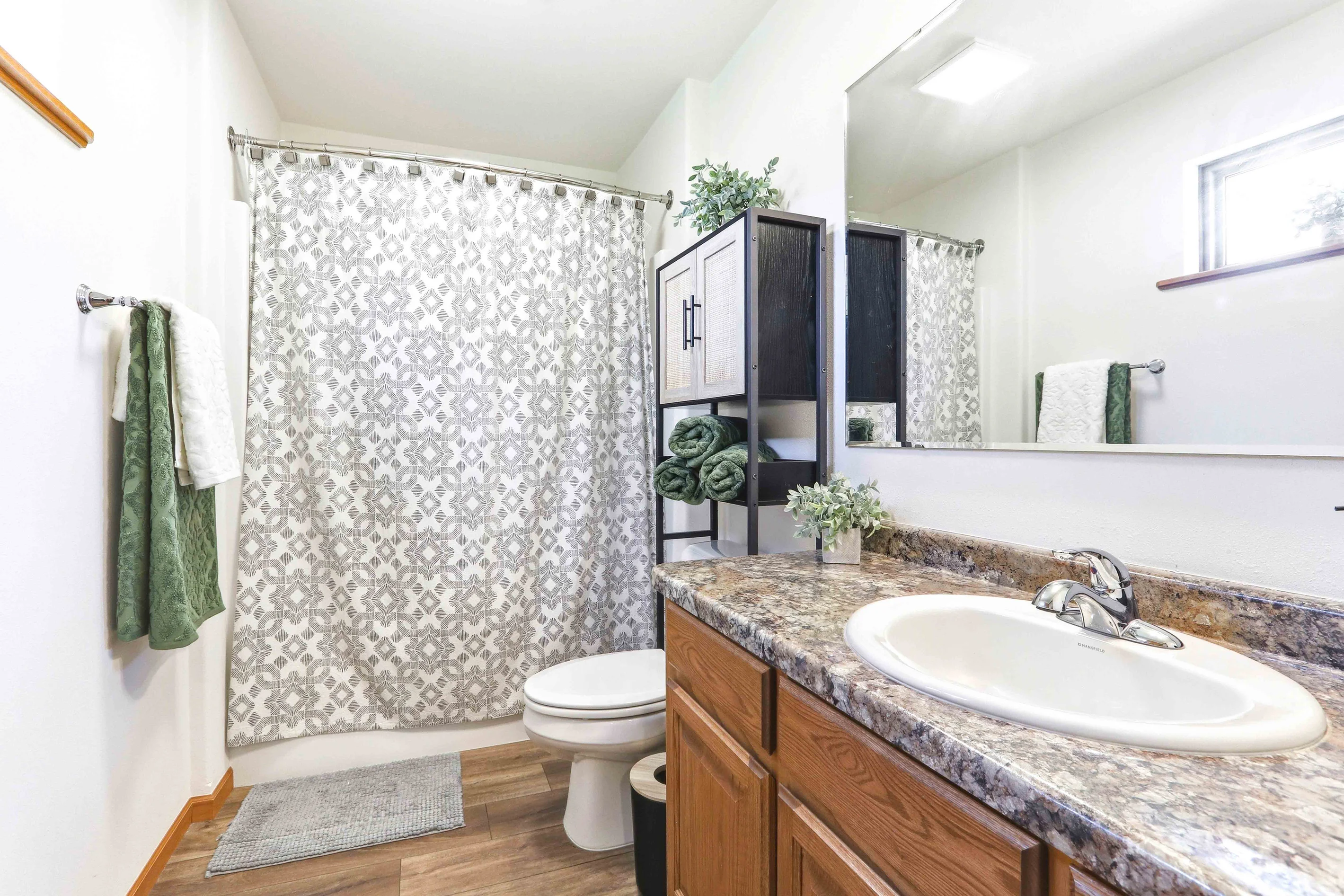 Master bathroom with double vanity and granite countertops in vacation rental near Sand Valley golf