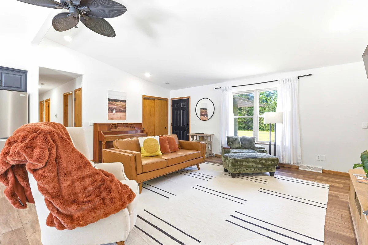 Bright living room with leather sofa and golf course view in Nekoosa, WI