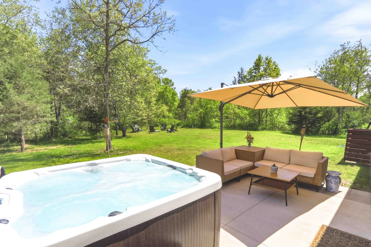 Backyard hot tub patio at a Nekoosa vacation rental near Sand Valley Golf Resort