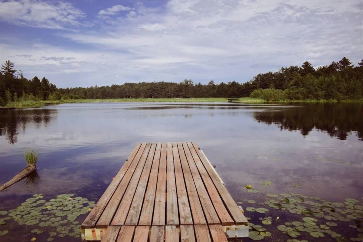 Wooden dock over calm lake near Minocqua, a feature of lakefront rental homes in Minocqua WI