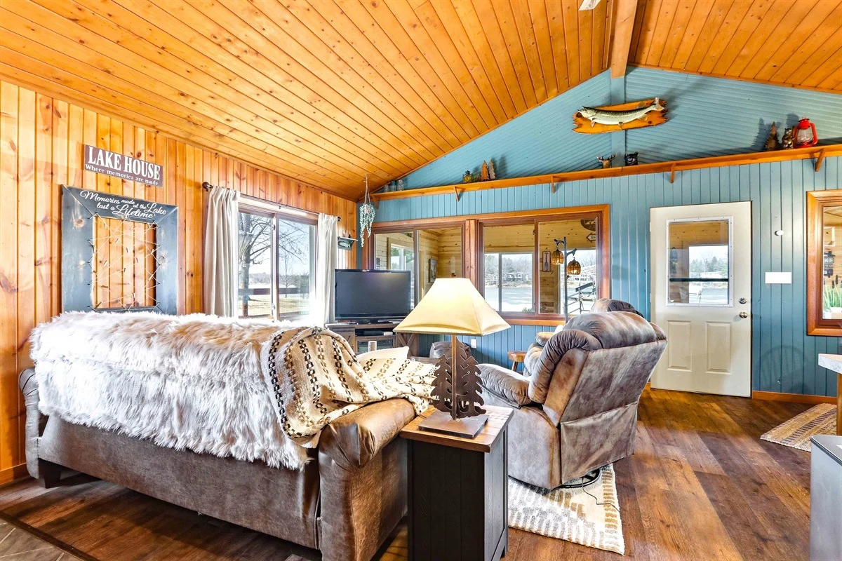Cozy lake house living room with wooden beams, rustic interior, and nautical décor in Nekoosa