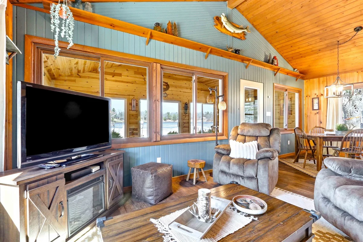 Modern log cabin living room with waterfront view and comfortable seating in Nekoosa WI