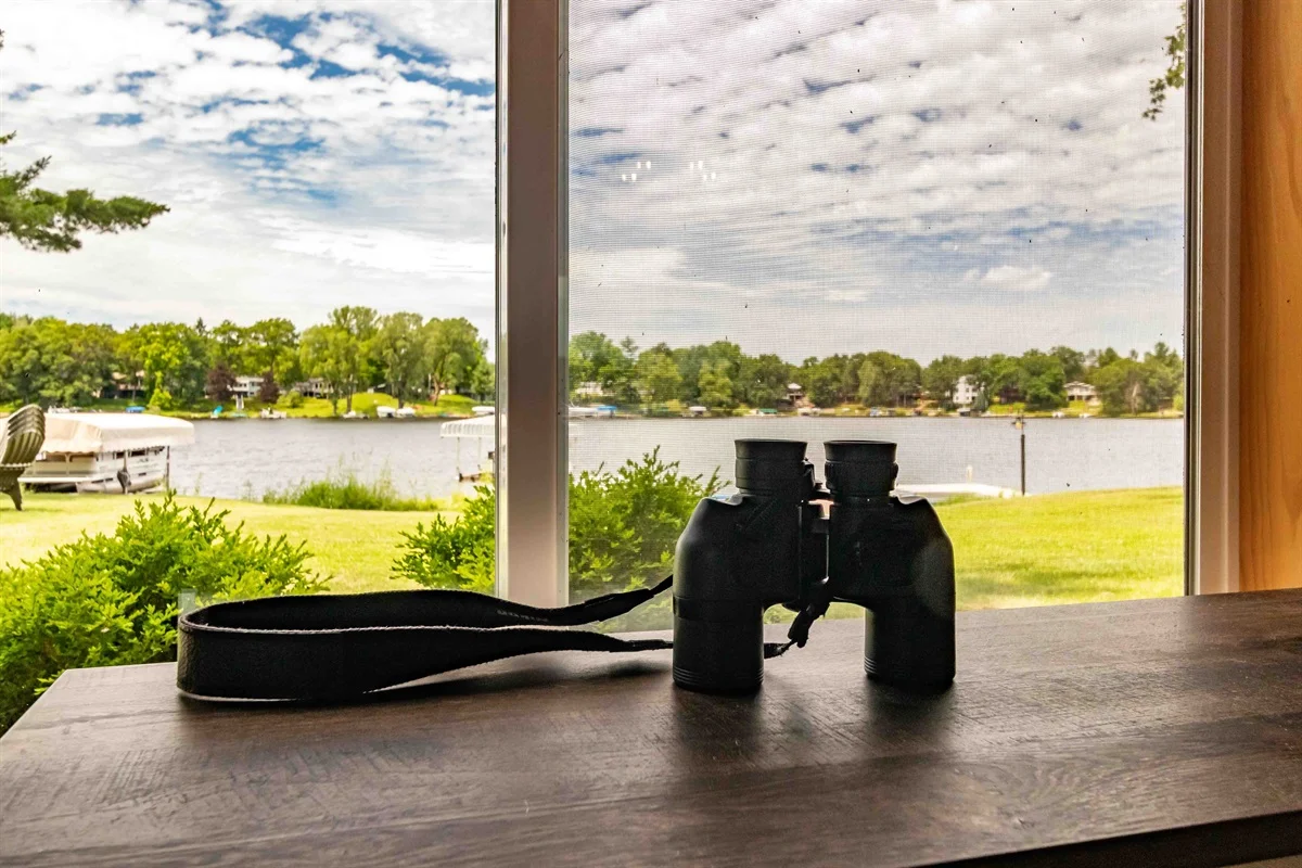 Lakefront Minocqua vacation rentals view with dock and boats through a cabin window